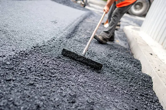 Asphalt raked during road construction